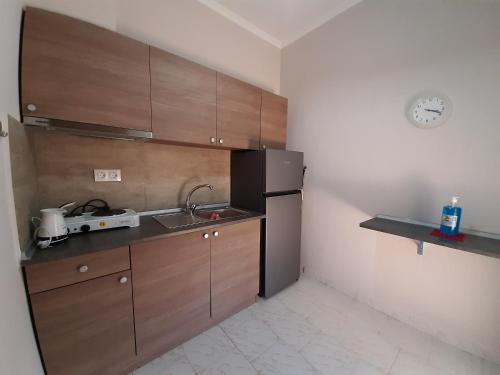 a kitchen with a black refrigerator and a sink at Latoura Studios in Ormos Panagias