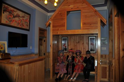 a group of four girls standing in a wooden room at Anh Trang Homestay in Da Lat