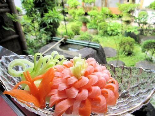 a glass bowl filled with orange and green artifictional at Ryokan Taishoro in Sakurai