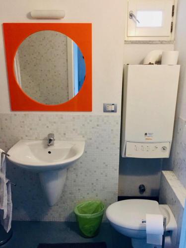 a bathroom with a sink and a toilet and a mirror at Da Marcella in Vernazza