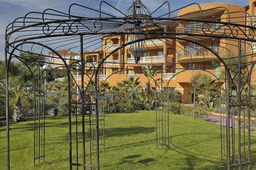 a large metal structure in the grass in front of a building at Appart Hotel Lou Castelet in Carros