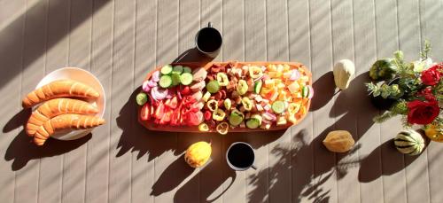 a tray of vegetables on a table next to a wall at Birs Vendégház in Jászberény