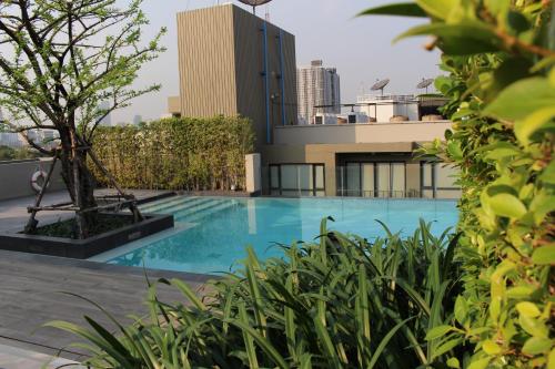 a swimming pool on the roof of a building at Alix Bangkok Hotel in Bangkok