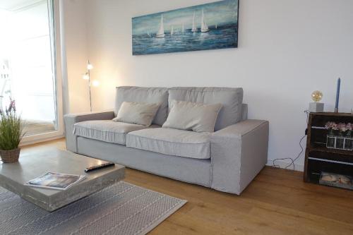 a living room with a couch and a coffee table at Kleine Auszeit in Timmendorfer Strand