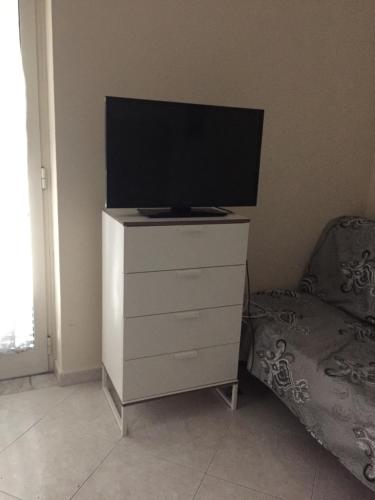 a tv on top of a dresser in a room at Maria's home in Pompei