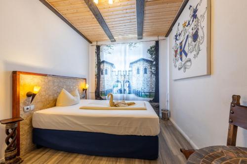 a bedroom with a large bed in a room at Landgasthof Eschbacher Katz in Usingen