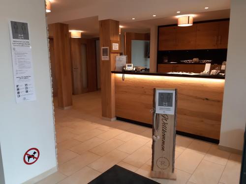 a lobby of a hotel with a counter with a sign at Rossano Boutique Hotel & Ristorante in Ansbach