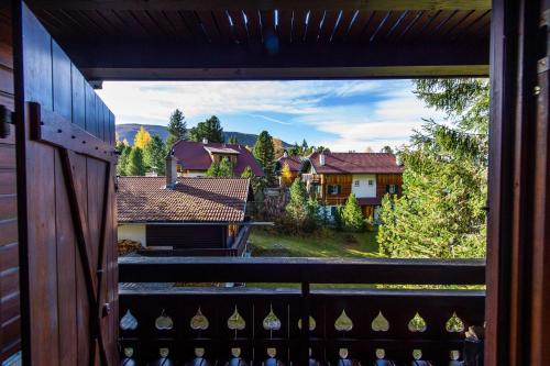 a view of a house from a balcony at Berghaus Turracherhöhe in Turracher Hohe