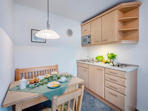 a kitchen with a table with food on it at Gäste- und Appartementhaus Stachl in Waging am See