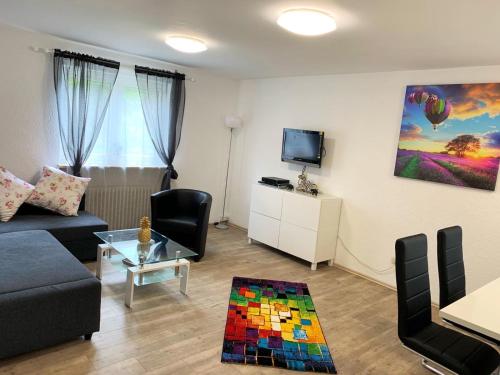 a living room with a couch and a tv at Ferienwohnung Familie Schott in Schwaig bei Nürnberg