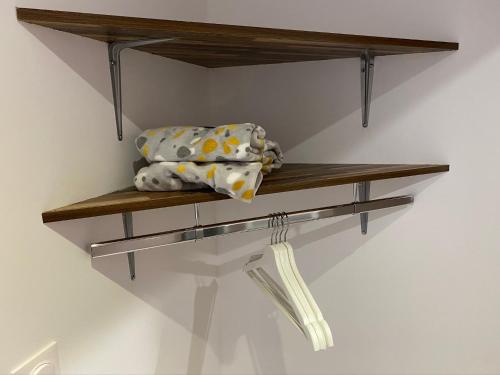 a wooden shelf on a wall with pillows on it at Logements équipés à Onnaing avec espace Balneo en OPTION proche Toyota, autoroute et Valenciennes in Onnaing