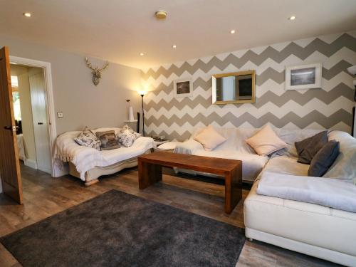a living room with two couches and a striped wall at 2 Snape Hill in Dronfield