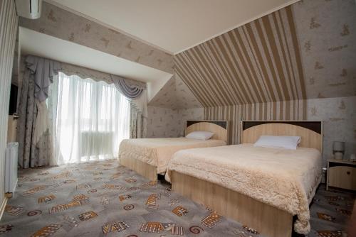 Кровать или кровати в номере Отель «Золотой Лев»