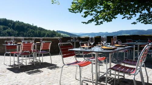 a group of tables and chairs with wine glasses at Schloss Burgdorf Youth Hostel in Burgdorf