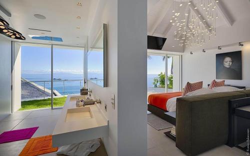 a bedroom with a bed and a view of the ocean at Dream Villa Corossol 643 in Gustavia