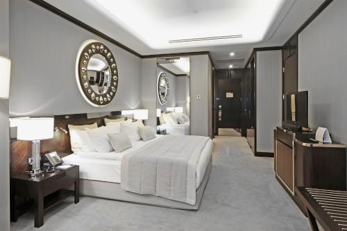 a bedroom with a large white bed and a television at Crowne Plaza Bursa Convention Center & Thermal Spa by IHG in Bursa