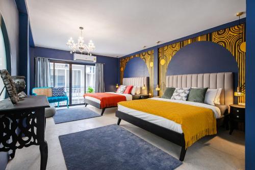 a bedroom with a king sized bed and a couch at The Mellow at Silom in Bangkok