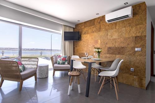 a dining room with a table and chairs at Terrazzos do Prado - Vista Ria de Aveiro in Costa Nova