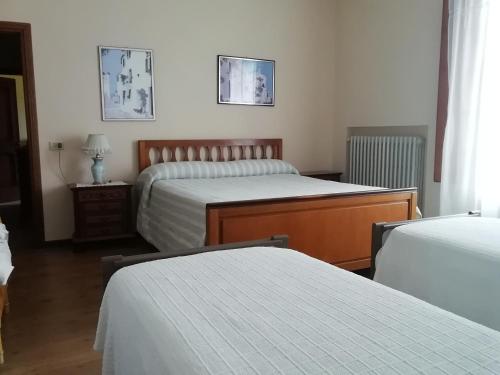a hotel room with two beds and a window at La collina degli olivi in Carmignano