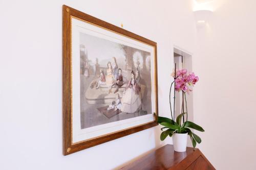 a painting on a wall with a vase of flowers at La Bizantina Luxury Villa in Positano