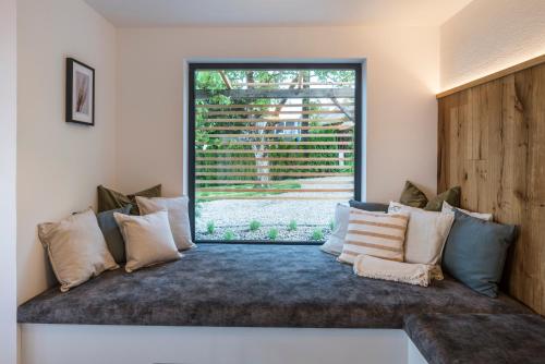 a room with a couch with a large window at steiRerBLiCke- Schilcherhaus in Greisdorf