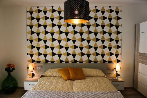a bedroom with a bed and a geometric wall at B&B Villa Pelèr in Lazise