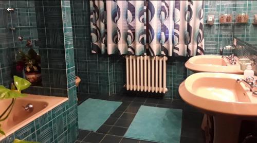 a bathroom with a sink and a bath tub and a sink at La collina degli olivi in Carmignano