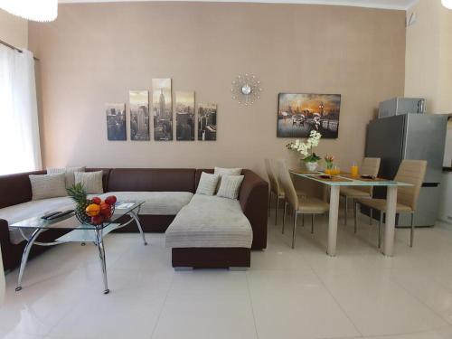 a living room with a couch and a table at DWIE SOSNY Apartamenty przy plaży - 365PAM in Ustronie Morskie