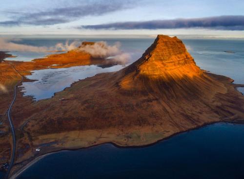 an aerial view of a small island in the ocean at Sudur-Bár Guesthouse in Grundarfjordur