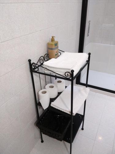 a towel rack in a bathroom with toiletries at Isi GuestHouse in Iesi