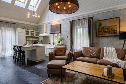 ein Wohnzimmer mit einem Sofa und einem Tisch in der Unterkunft Villa Louis in Ventspils