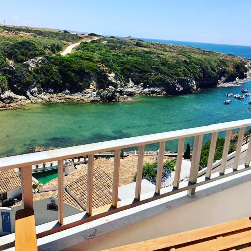 a view of a beach with boats in the water at Porto Covo Bay House in Porto Covo