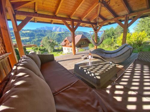 a couch on a porch with a view of a mountain at Ferienhaus Schaller am Galsterberg in Pruggern