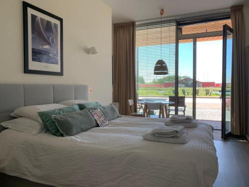 a bedroom with a bed with towels on it at Waterfront Studio in Amsterdam
