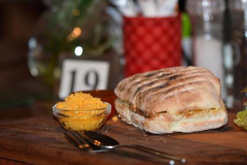 a loaf of bread and a bowl of food on a table at Dis Al in Oubosrand