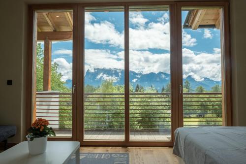 a bedroom with a large window with a view of mountains at Haus Lichtenstern in Soprabolzano