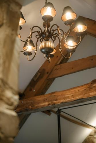 a chandelier hanging from a ceiling in a room at Shortflatt Tower Wings in Bolam