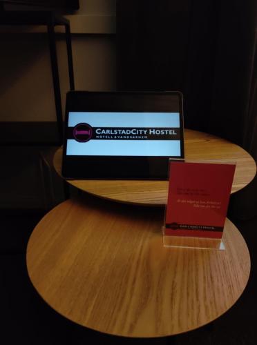 a laptop computer sitting on top of a wooden table at CarlstadCity H Boutique Hotell in Karlstad