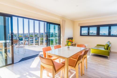 a dining room with a table and chairs at The Windsor, Hotel Rooms & Apartments in Brisbane