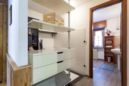 a kitchen with white cabinets and a sink at Bondine Apartments in Valle d'Aosta in Charvensod