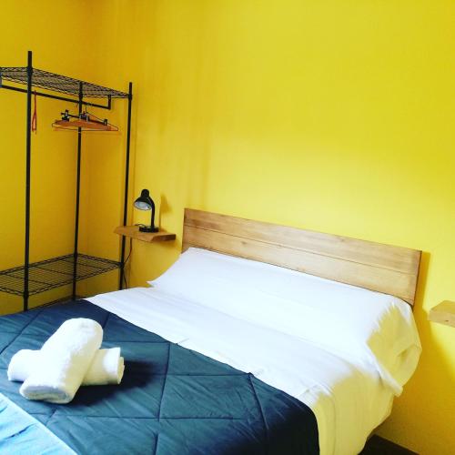 a bedroom with a bed with two towels on it at Txoko Maitea Pentsioa in Urnieta
