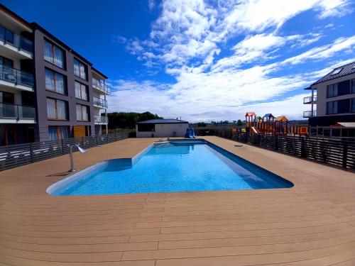 a large swimming pool on a roof of a building at Apartament PLUS 22 C in Sarbinowo