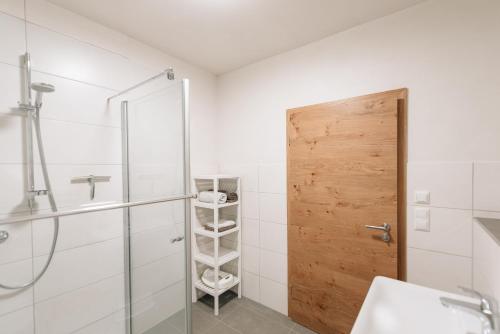 a bathroom with a shower and a glass door at Wallochny-Hof in Marktbreit