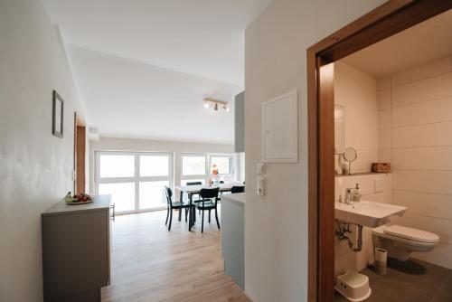 a bathroom with a sink and a toilet and a table at Wallochny-Hof in Marktbreit