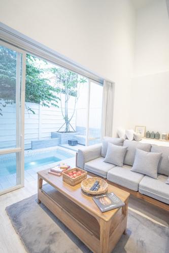 a living room with a couch and a coffee table at Any Day House Chiang mai in Chiang Mai