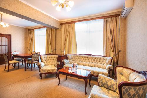 a living room with a couch and chairs and a table at Готель Дніпро in Kyiv