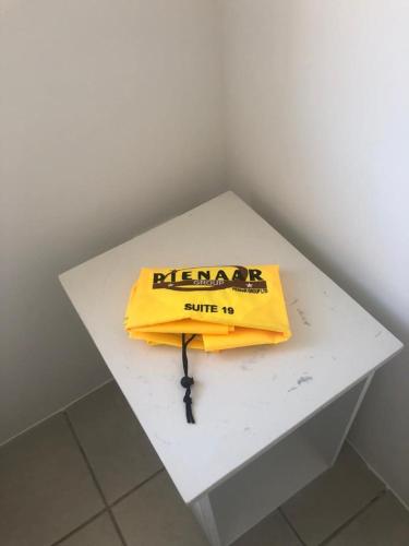 ein gelber Beutel auf einem weißen Tisch in der Unterkunft The Square 11 Private Suite in Port Elizabeth