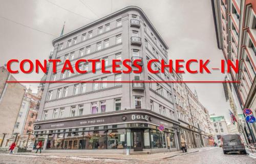 a sign that reads confidence check on a building at Greystone Suites & Apartments in Riga