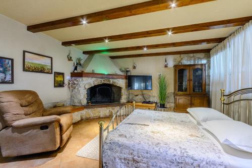 een woonkamer met een bed en een open haard bij Villa Secluded Paradise in Omiš