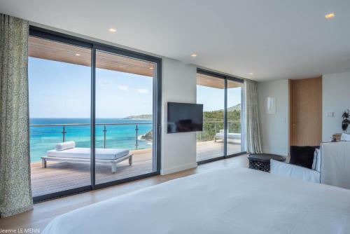 a bedroom with a view of the ocean at Dream Villa Anse des Cayes 809 in Anse des Cayes